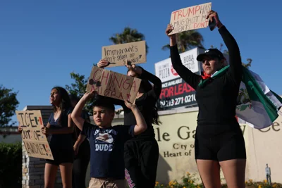 People peacefully protest following social reports of federal immigration operations by Immigration and Customs Enforcement (ICE) in Lawndale, California on June 18, 2025. Calm appeared to be returning to protest-hit Los Angeles on June 17 as the mayor lifted a nighttime curfew, while US President Donald Trump battled to keep control of California troops he deployed to the city. Roughly half of the stores have begun taking down the plywood that had been put up to protect their windows. A fraction of the sprawling US city had been off-limits from 8pm to 6am to most people for a week after instances of looting and vandalism during demonstrations against Trump's immigration raids. (Photo by Patrick T. Fallon / AFP) (Photo by PATRICK T. FALLON/AFP via Getty Images)