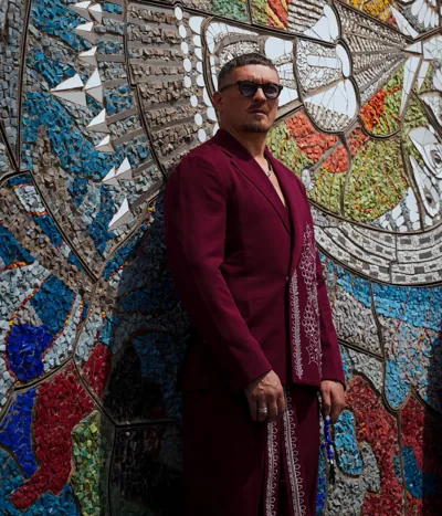 Oleksandr Usyk stands in front of a meticulous recreation of the symbolic mosaic reflecting Ukrainian identity (Picture: ROZETKA)