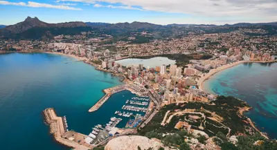 Aerial drone picturesque view from above Calp cityscape salt lake, bay of Mediterranean Sea the both sides photo taken from Penon de Ifach rock. Province of Alicante, Calpe, Costa Blanca, Spain