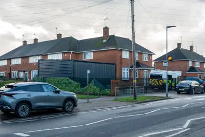 The entrance to the large garage on Aycliffe Road, situated near a pedestrian crossing.