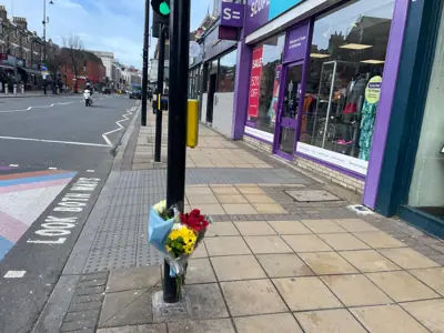 Image: Floral tributes left at the scene of the Wimbledon stabbing.