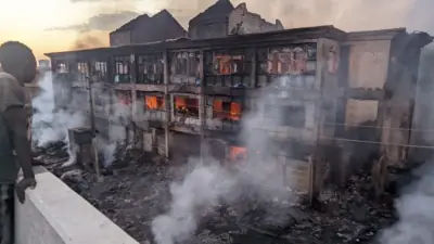 Firefighters tackling the large blaze at Kano's Singer Market. Firefighters tackling the large blaze at Kano's Singer Market.