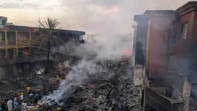 Firefighters tackling the large blaze at Kano's Singer Market.
