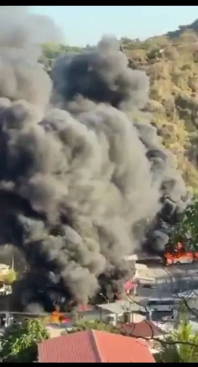 Emergency services responding to a scene of a burning vehicle on a Mexican road.
