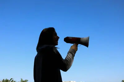 Woman using a megaphone, symbolising the disruptive noise caused to neighbours.