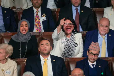 Democratic Representatives Ilhan Omar and Rashida Tlaib protesting during Donald Trump's State of the Union address.