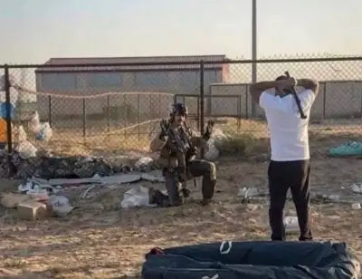 A Kuwaiti man, holding a metal pipe, confronts a US pilot he initially mistook for an Iranian pilot.
